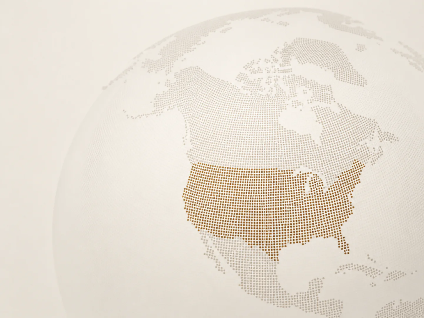Dotted globe centered on North America with the United States highlighted in muted bronze.